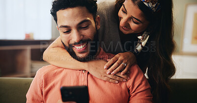 Buy stock photo Hug, happy and couple on sofa with phone for bonding, loving relationship and relax together in home. Love, apartment and man with woman embrace on smartphone for social media, website and internet