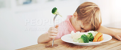 Buy stock photo A little boy very unhappy with having to eat vegetables