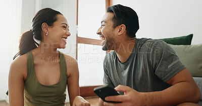 Buy stock photo Happy couple, laughing and funny joke with phone for comedy, humor or social media during workout at home. Active man and young woman with smile on mobile smartphone for goofy or silly news at house