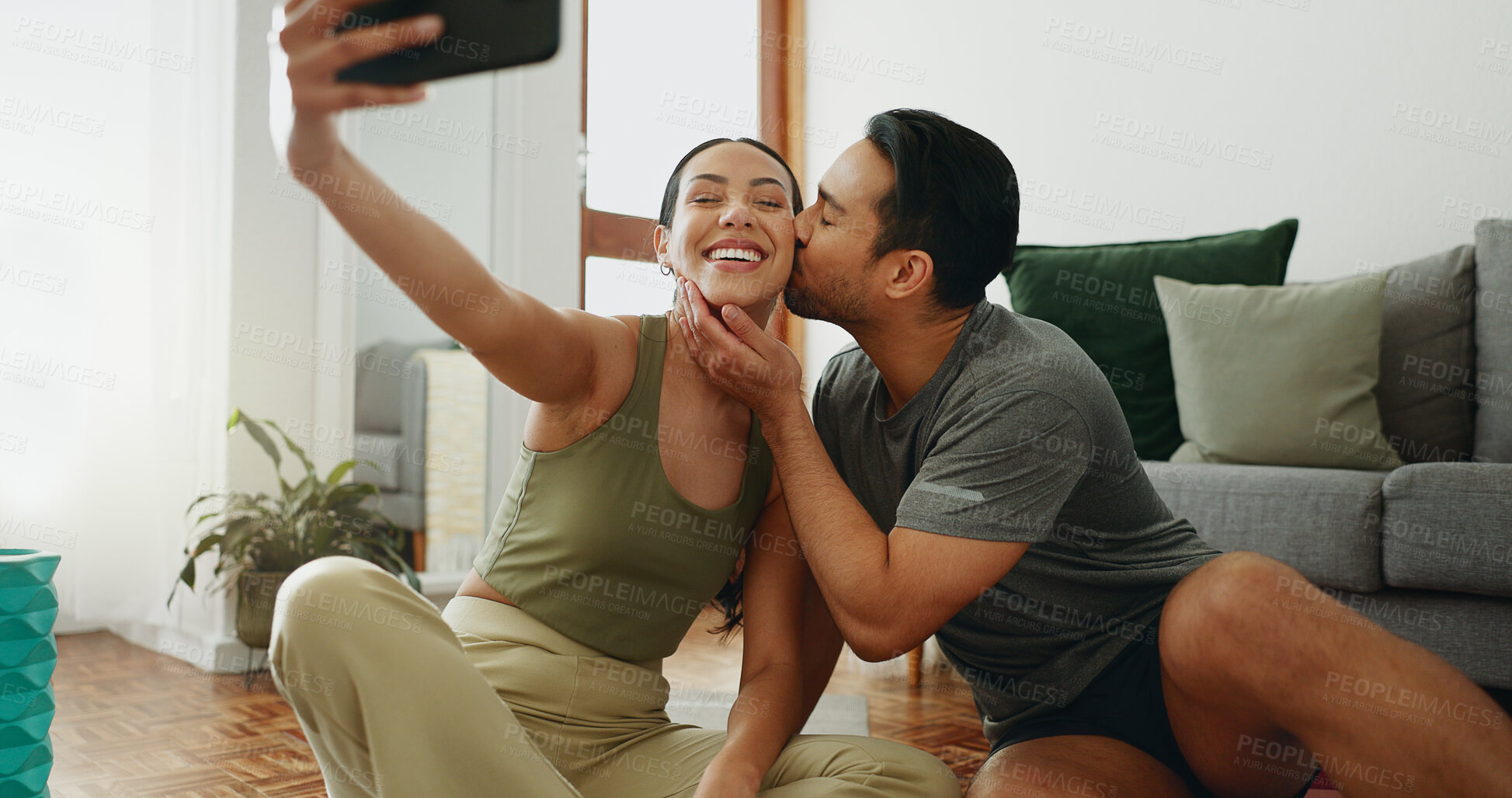 Buy stock photo Happy couple, fitness and selfie with kiss on cheek in workout, exercise or indoor training together at home. Young woman and man with love or smile for photography, memory or picture moment at house