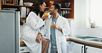 Couple, smile and love in kitchen with orange juice, happiness and fun in relationship. Man, woman and drink in home for conversation, bonding and relax in morning or excited for anniversary or trust