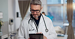 Man, doctor and reading on tablet at clinic for Telehealth consultation, healthcare charts and medical information. Male person, digital and review surgery schedule, diagnosis report and test results