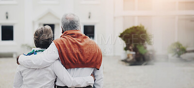 Buy stock photo Rear view of a senior couple embracing each other in the courtyard of their hotel