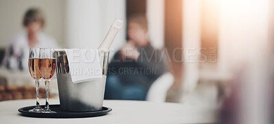 Buy stock photo A champagne bottle and two champagne glasses on a restaurant table