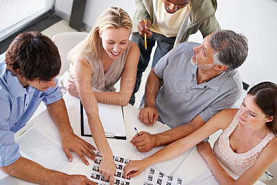 Buy stock photo A group of designers having a brainstorming session around a table