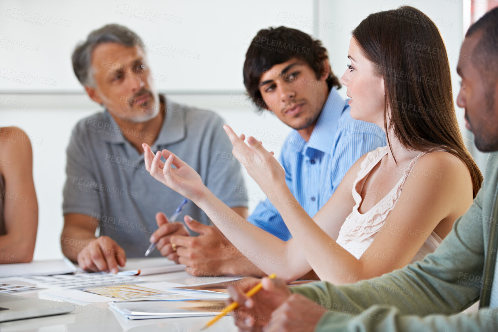 Buy stock photo A gorgeous young brunette involved in an exciting new business project in the boardroom