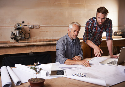 Buy stock photo Cropped shot of a father and son working together in their workshop