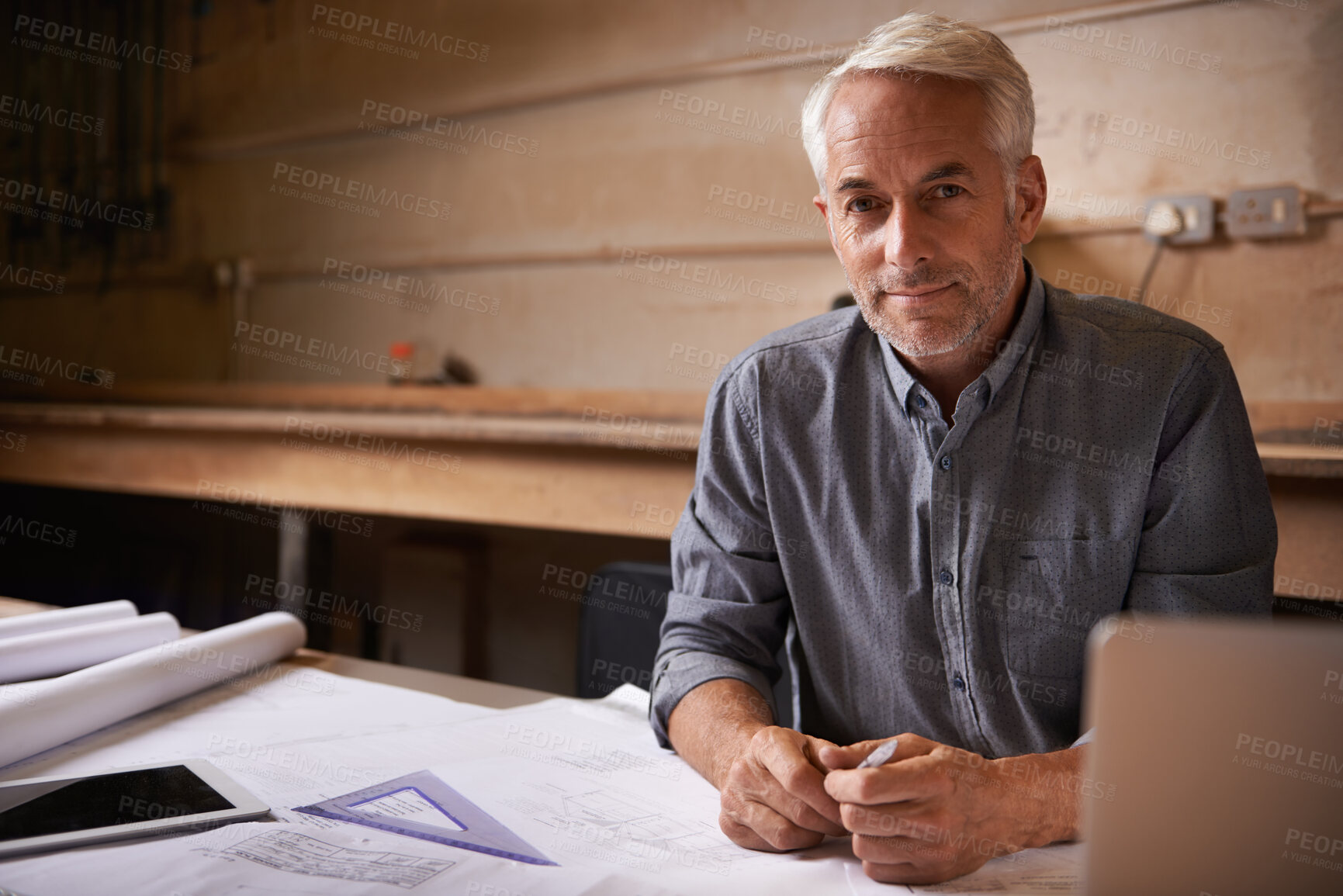 Buy stock photo An architect drawing up plans