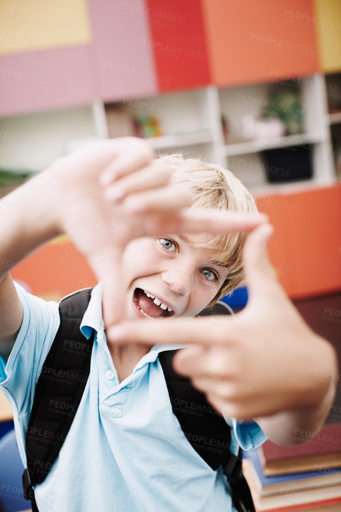 Buy stock photo Finger, frame and boy with funny portrait in classroom for creative imagination, education perspective and happy. Learner, person and hand emoji at elementary school for learning, shape and symbol