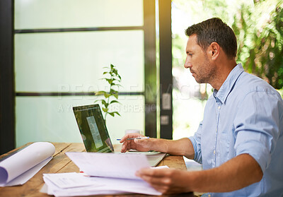 Buy stock photo Man, thinking and laptop with paperwork for remote work from home office for architecture project. Person, computer and reading with reflection, insight and inspiration for design documents in house