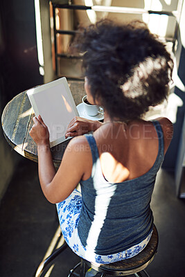 Buy stock photo Shot of a young woman using a digital tablet in a cafe