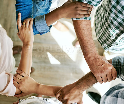 Buy stock photo Business people, holding hands and support in office with teamwork, solidarity or partnership goals. Diversity synergy, employees or group collaboration with top view for unity, cooperation and trust