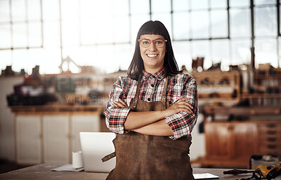 Buy stock photo Cropped portrait of an attractive young woman standing with her arms folded in her creative workshop