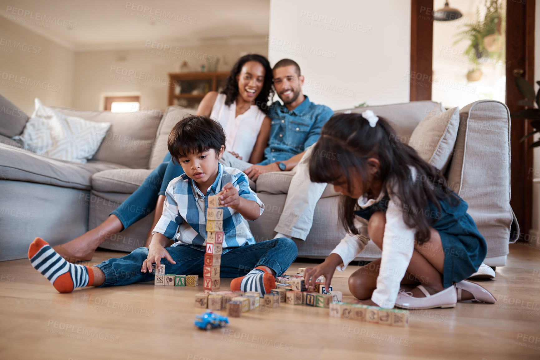 Buy stock photo Kids, building blocks and activity in home, learning and siblings bonding together on lounge floor. Children, brother and sister with educational toys, parents watching and love for mind development