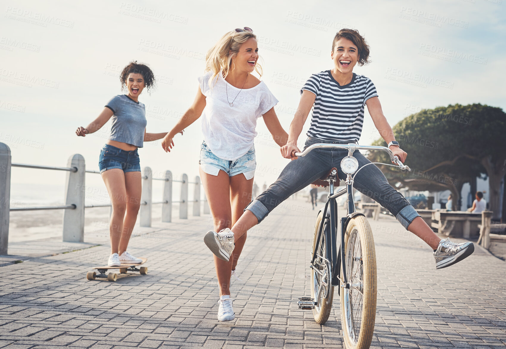 Buy stock photo Bike, friends and skateboard with women in summer for sports, fun and holiday break. Health, joy and wellness with cyclists riding bicycle on promenade for relaxing, Miami travel and freedom together