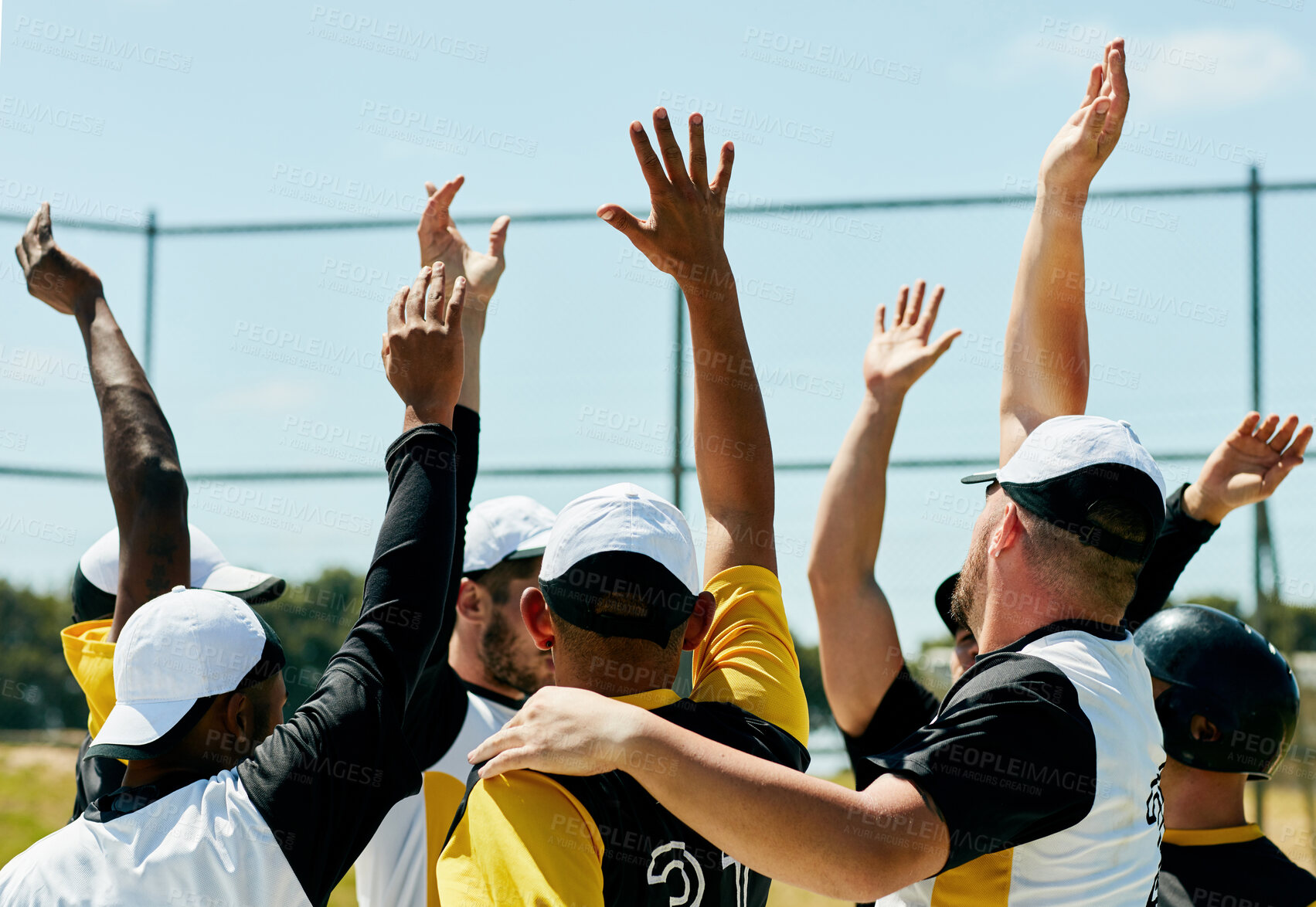 Buy stock photo Cropped shot of a team of young baseball players cheering with their arms raised while standing on the field during the day