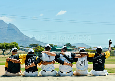 Buy stock photo Rearview shot of a team of unrecognizable baseball players embracing each other while sitting near a baseball field during the day