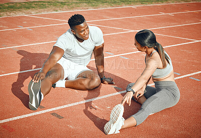 Buy stock photo High angle shot of a young athletic couple warming up before starting their outdoor exercise routine