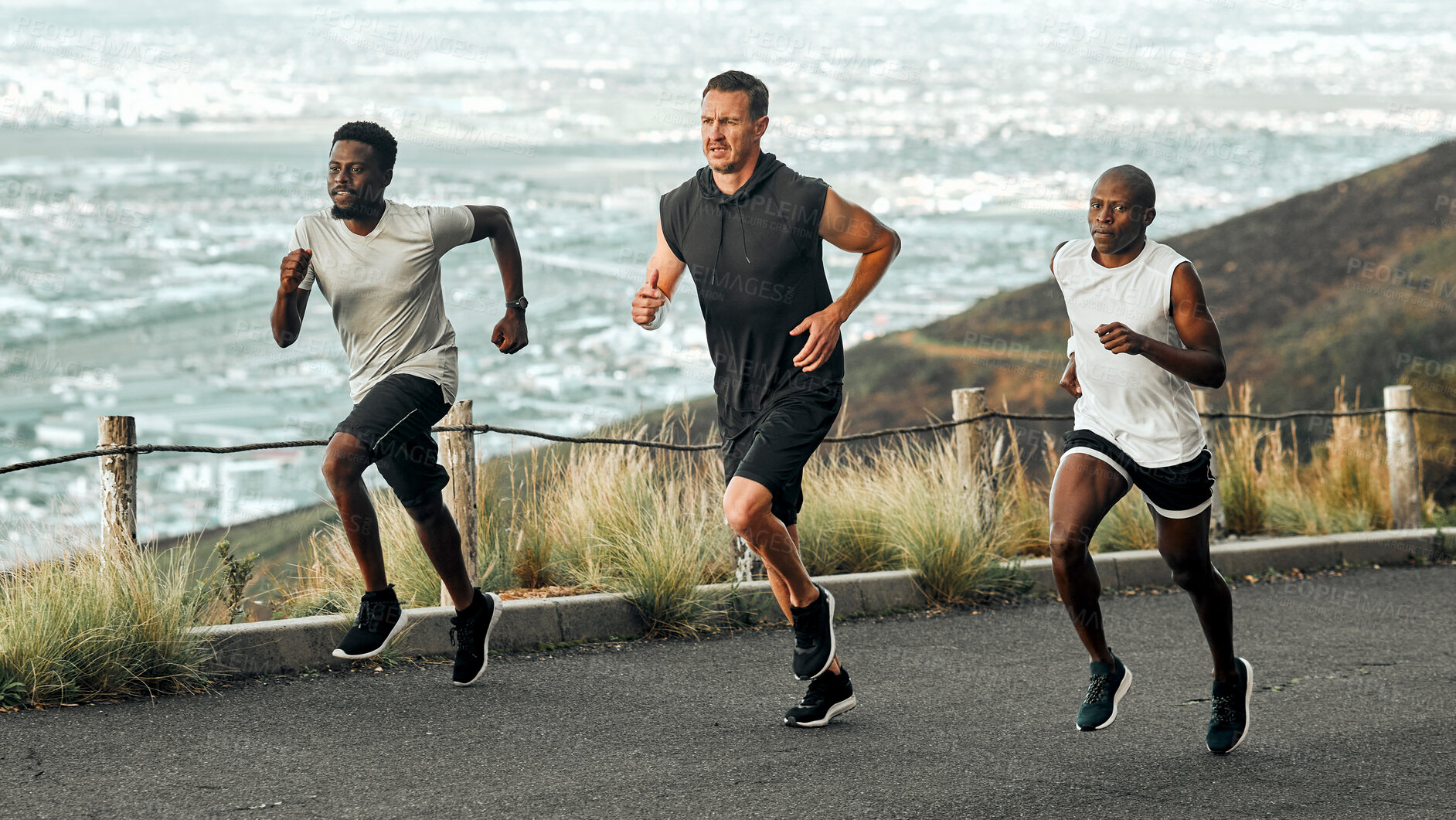 Buy stock photo Shot of a group of men exercising in nature