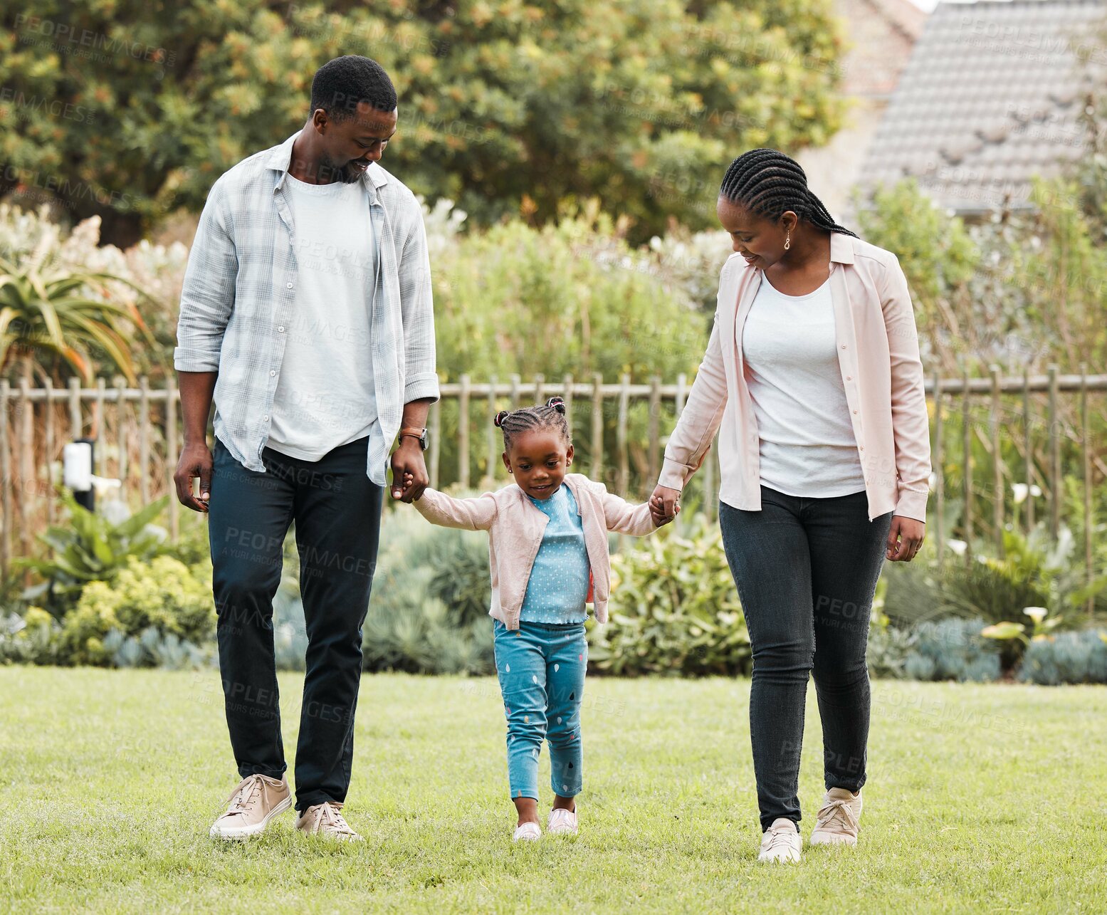 Buy stock photo Black family, walking and outdoor with kid, relax and together for love in relationship. People, parents and holding hands with daughter for support, garden and trust mom or dad in backyard of home