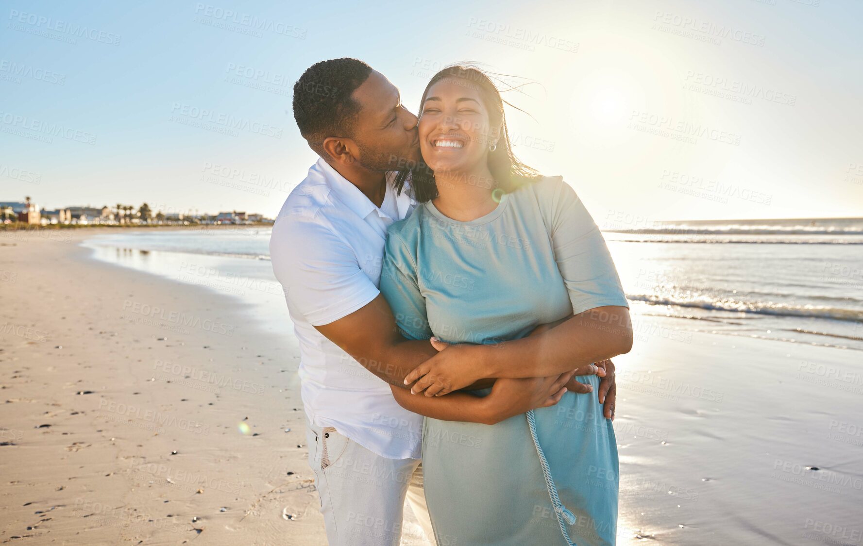 Buy stock photo Hug, romantic or happy couple kiss at beach to travel for love on vacation, valentines day or holiday. Tropical break, laughing or people bonding together at sea or ocean for honeymoon trip on island