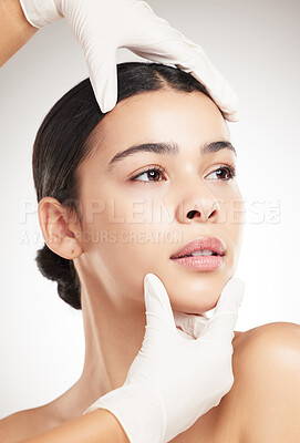 Buy stock photo Hands, gloves and woman for plastic surgery in studio with facial check, rhinoplasty and medical transformation. Girl, surgeon and reconstruction with aesthetic, filler procedure and white background