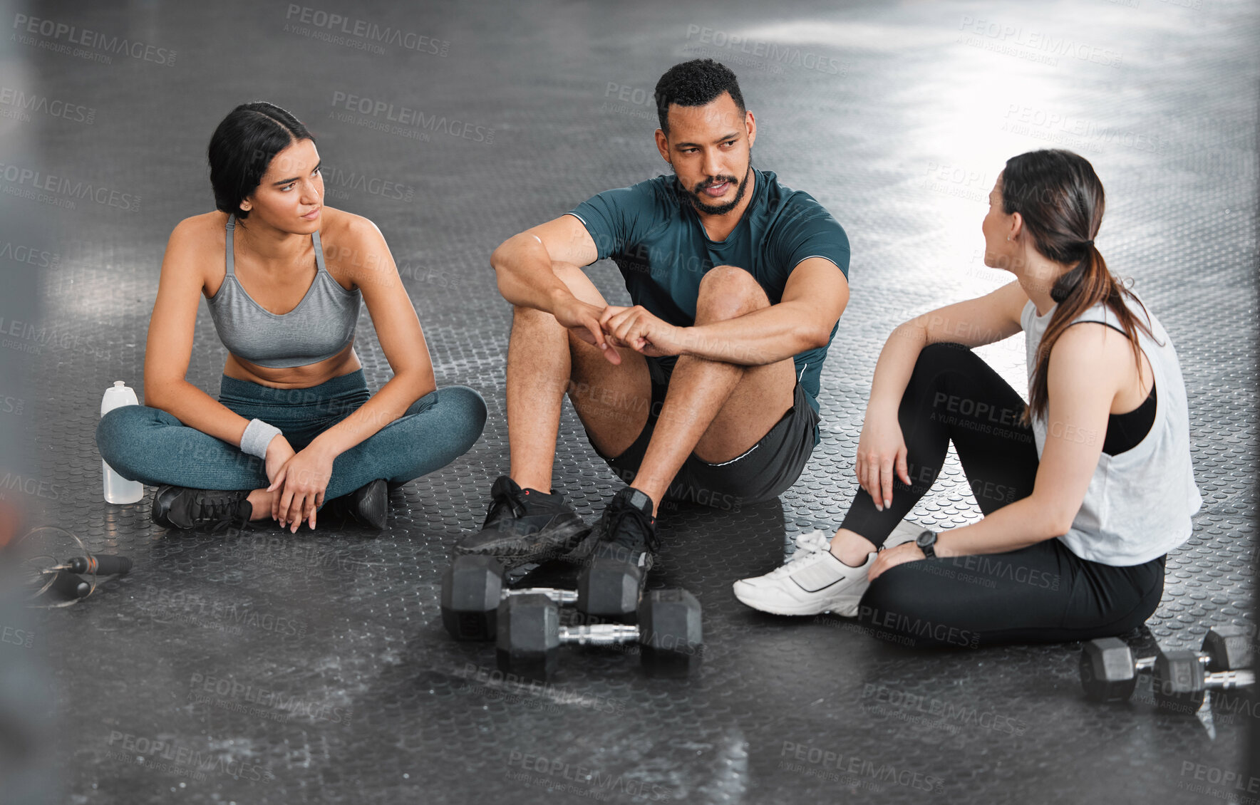 Buy stock photo Fit, active and healthy gym team talking, bonding and planning workout, training and exercise in wellness center. Sporty, athletic or strong man and women on break from intense dumbbell weightlifting