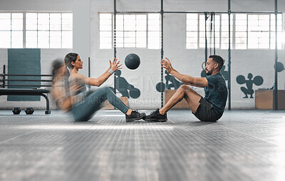 Buy stock photo Active, sporty fitness couple or gym partners training together, doing abs exercises by throwing a weighted slam ball. Male trainer and female athlete in motion focused on workout session or class.