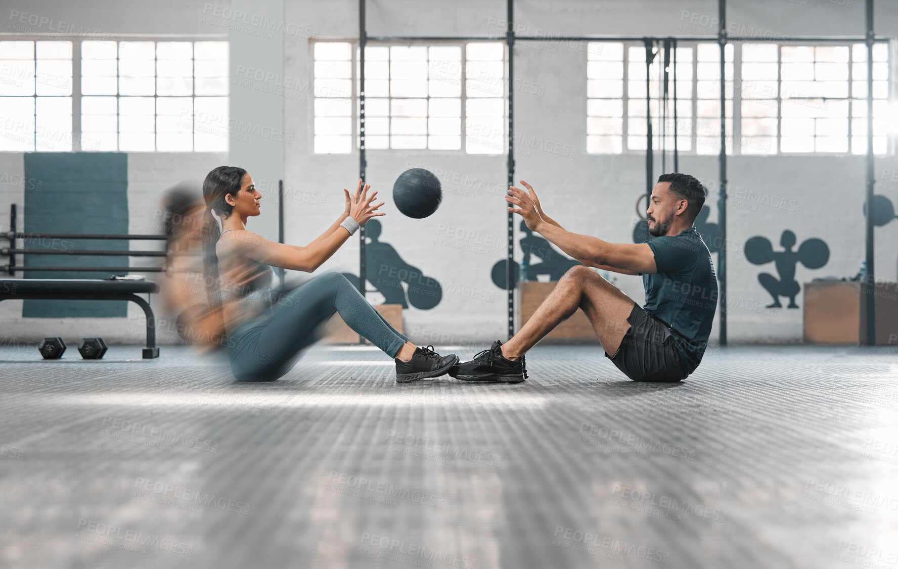 Buy stock photo Active, sporty fitness couple or gym partners training together, doing abs exercises by throwing a weighted slam ball. Male trainer and female athlete in motion focused on workout session or class.