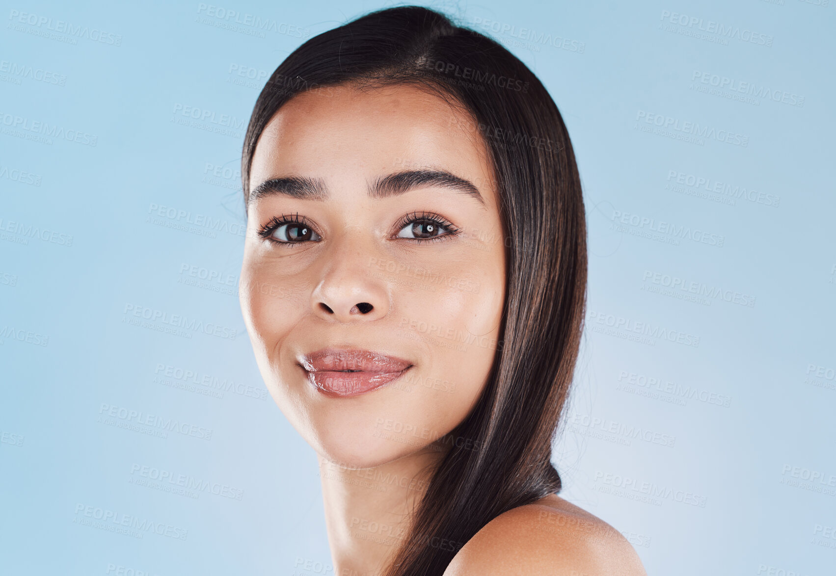 Buy stock photo Woman, portrait and happy for skincare in studio with natural beauty, self care glow or dermatology treatment. Model, girl and smile with skin hydration facial and mockup on blue background in Brazil