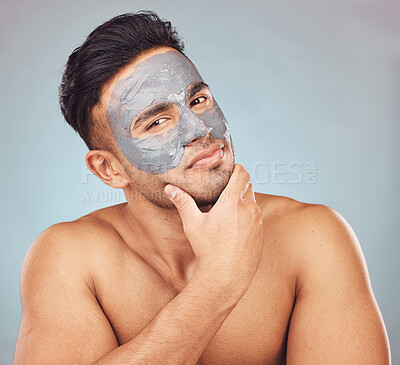 Buy stock photo Skincare, portrait and man with mask, clay facial treatment and mud product for skin glow on blue background. Cosmetics, dermatology and male person with charcoal detox for morning routine in studio