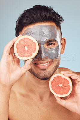 Buy stock photo Man, natural and portrait for skincare, face mask and cleaning on studio background with grapefruit. Male person, dermatology and organic charcoal facial for skin and hydration with beauty cosmetics