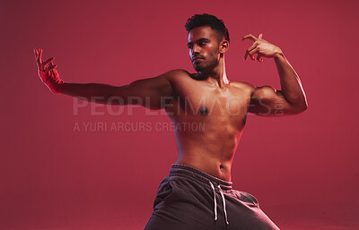 Buy stock photo Man, martial arts and studio with fitness, action and ready for fight training by red background. Person, athlete or shirtless with combat sports, workout and exercise with muscle, wellness or health