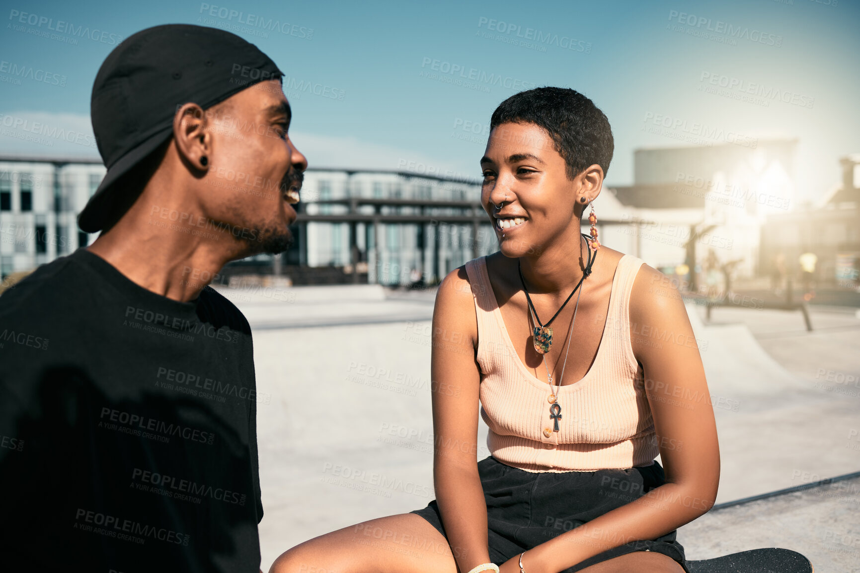 Buy stock photo Happy, smile and couple talking in the city while relaxing outdoor together on summer vacation with flare. Happiness, communication and young man and woman from Mexico speaking in a urban town.