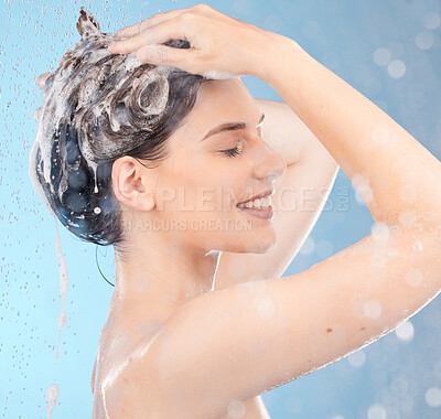 Buy stock photo Woman, shampoo and shower for hair care, clean or hygiene on blue studio background. Young female, girl or lady wet, water or bubbles for natural beauty, morning routine or skincare to relax or smile