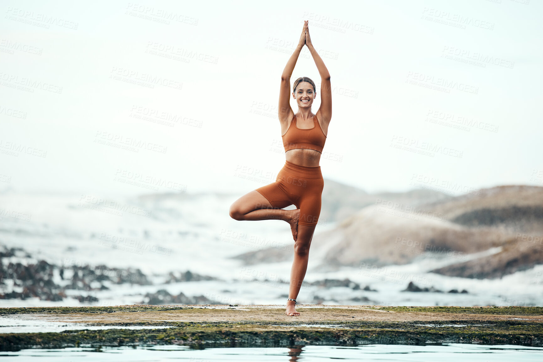 Buy stock photo Yoga, woman and stretching on beach, workout or fitness for balance, wellness or health. Female, girl or exercise for training on seaside, zen or practice for performance, healthy or energy for power