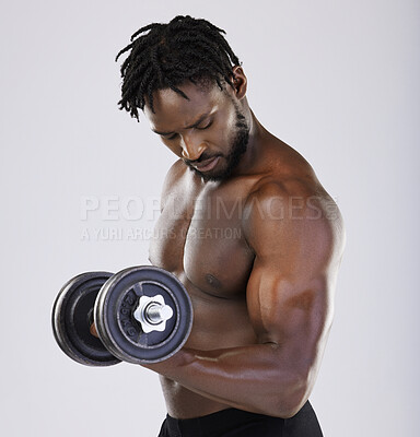 Buy stock photo Dumbbell, exercise and fitness of a strong black man doing muscle workout in studio. Body of sexy bodybuilder person training with weight for power, health and wellness or growth as sports motivation