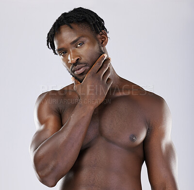 Buy stock photo Black man, muscle and standing isolated on a grey background thinking, grooming or profile. Portrait of fit or attractive African American male, person or guy model in thought posing in the studio