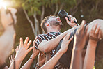 Crowd, surfing and man singing at party, outdoor music festival or social gathering. Microphone, energy and male singer diving in audience group at performance event, celebration or crazy fun weekend