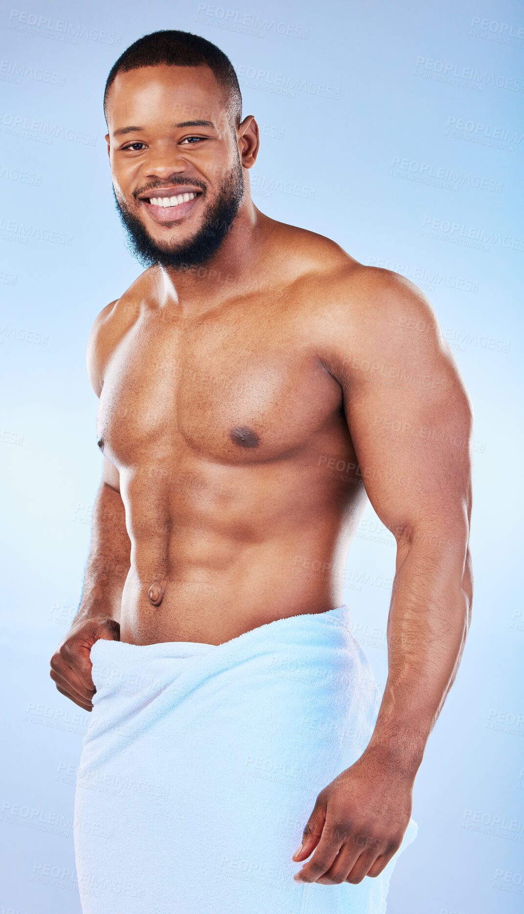 Buy stock photo Black man, bodybuilder and towel in studio portrait with smile, wellness or start to morning by blue background. Youth african guy, body and skincare with happiness, health and self care by backdrop