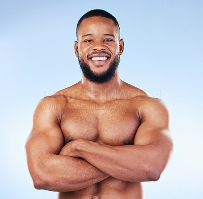 Buy stock photo Muscle, fit and portrait of a black man with arms crossed isolated on a blue background in studio. Happy, pride and African bodybuilder with fitness confidence, arm power and strength on a backdrop