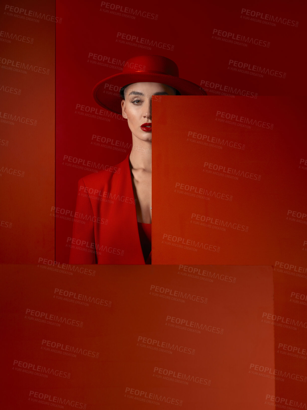 Buy stock photo Portrait, fashion and mock up with a woman on a red studio background for marketing, advertising or branding. Luxury, aesthetic style and hat with a young female model standing with empty space