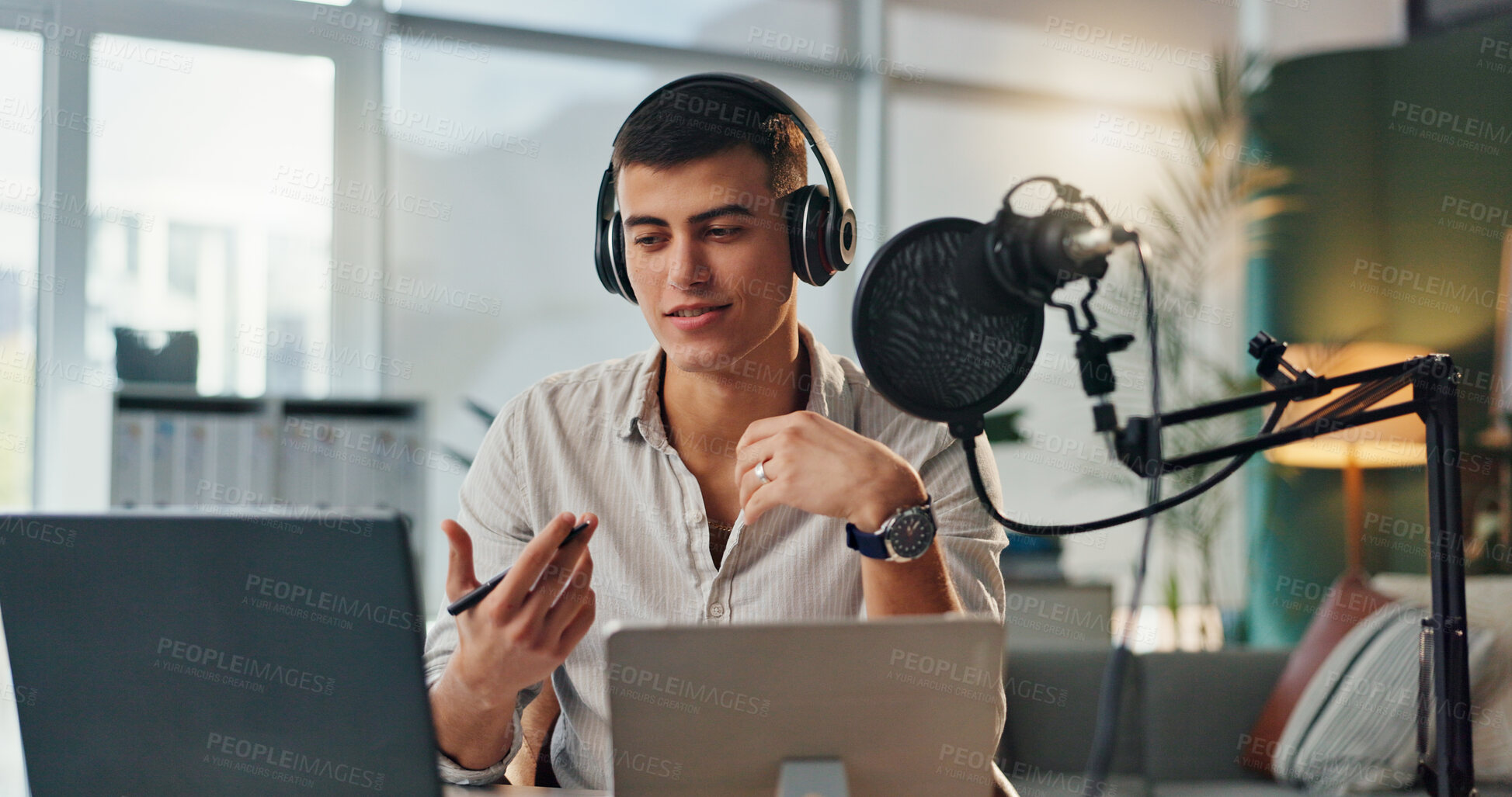 Buy stock photo Podcast, news presenter and radio show host with man speaking about public relations and live streaming. Laptop, microphone and speaker with interview discussion, audio and dj hosting in home studio