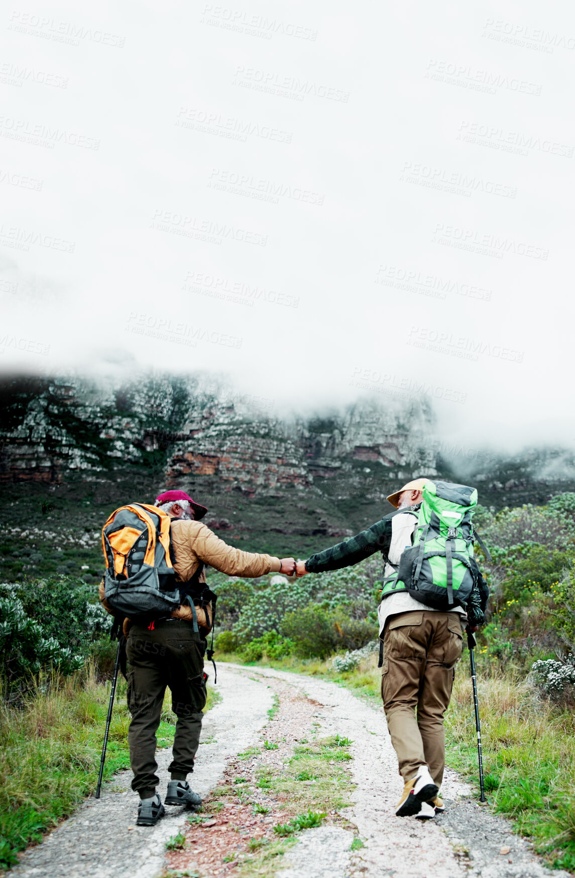 Buy stock photo Nature, fist bump or friends on trail hiking outdoor adventure or journey in forest for mountain travel. Clouds, path or people in woods for holiday vacation, walking or trekking to explore together