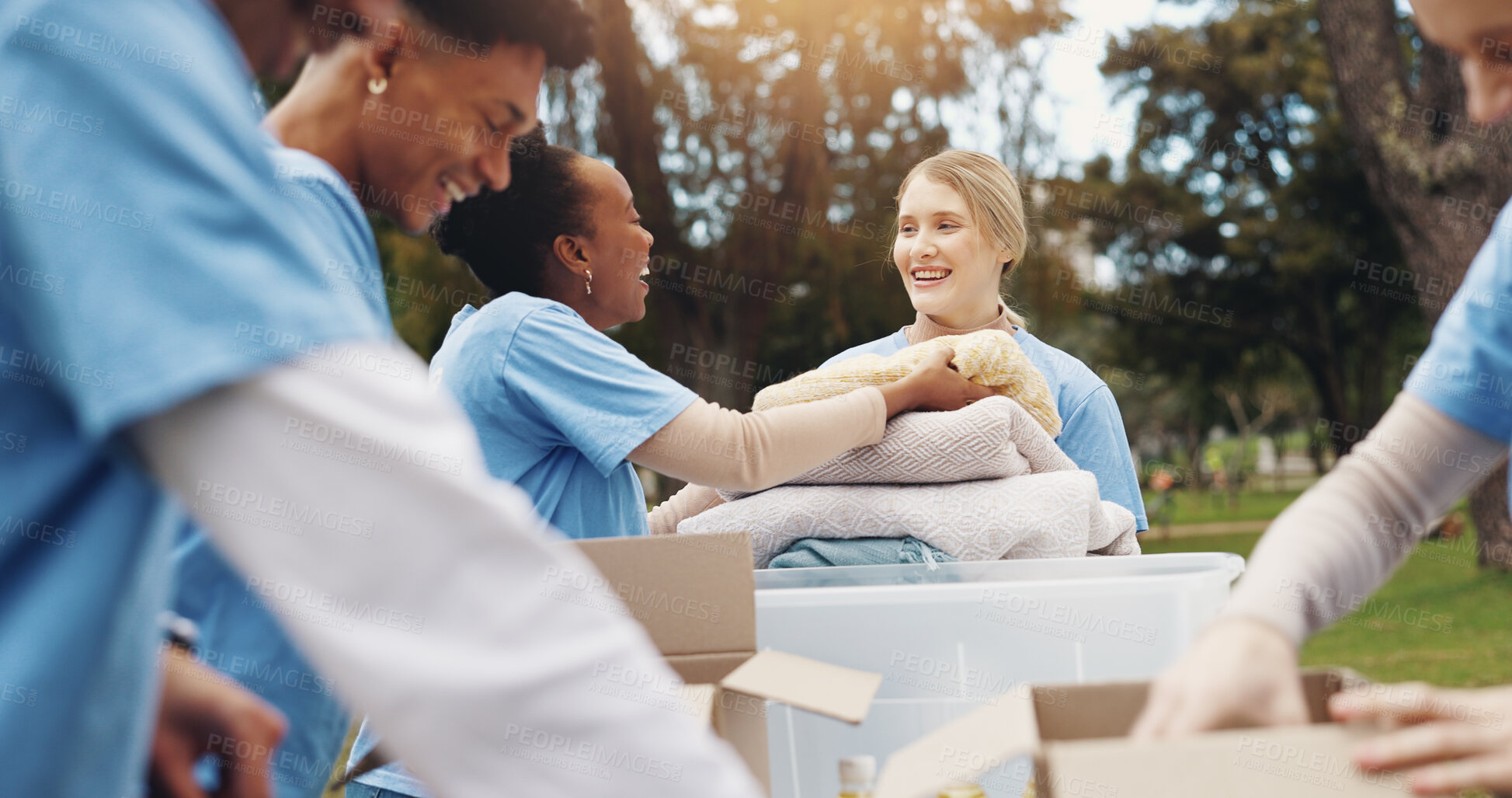 Buy stock photo Donation, volunteer and group of people in park together for sustainability, teamwork and ngo project. Solidarity, men and women at table for outdoor charity, community care and social responsibility