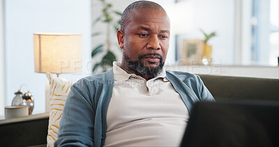 Buy stock photo Laptop, reading and black man on sofa in home for research on holiday planning with flight ticket. Computer, living room and African person browsing online for review for hotel booking with travel.