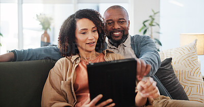 Buy stock photo Couple, relax and discussion with tablet on sofa for online order, communication and decision on lunch. Interracial, man and woman with technology at home for takeout app, choice and food delivery