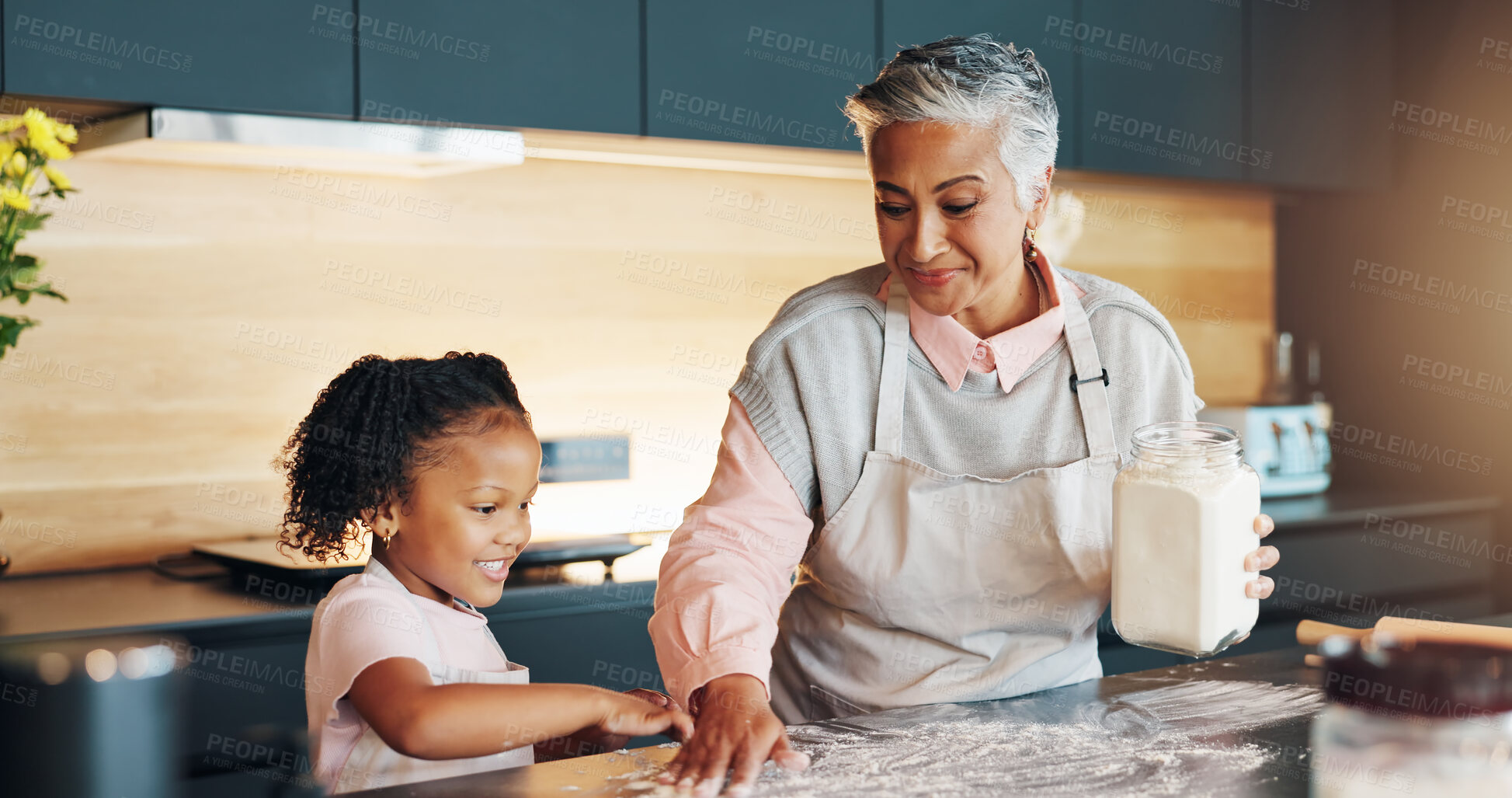 Buy stock photo Grandmother, little girl and baking with flower on table in kitchen for learning, teaching or helping hand at home. Happy grandma, child or junior baker preparing dessert, cookies or ingredients