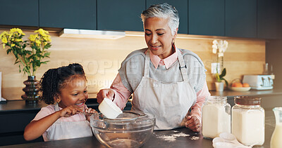 Buy stock photo Baking, child and helping grandmother with preparation for cookies, dessert and childhood development. Flour, baker woman and girl bonding in kitchen with teaching cake recipe, support and education