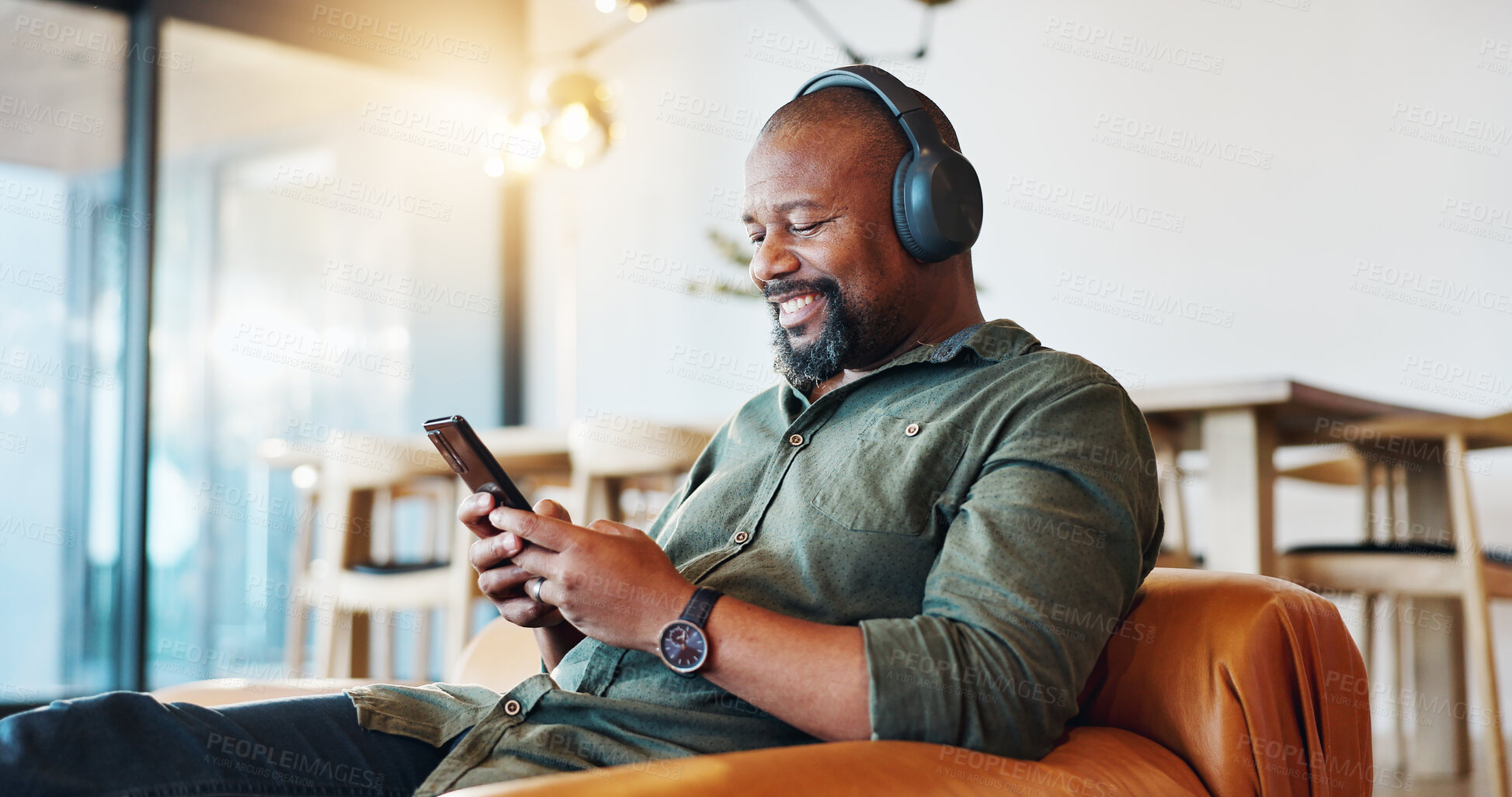 Buy stock photo Headphones, cellphone and black man in home with happiness for online music, playlist or album review. Smile, audio tech and African male person with phone for streaming radio, podcast or video.